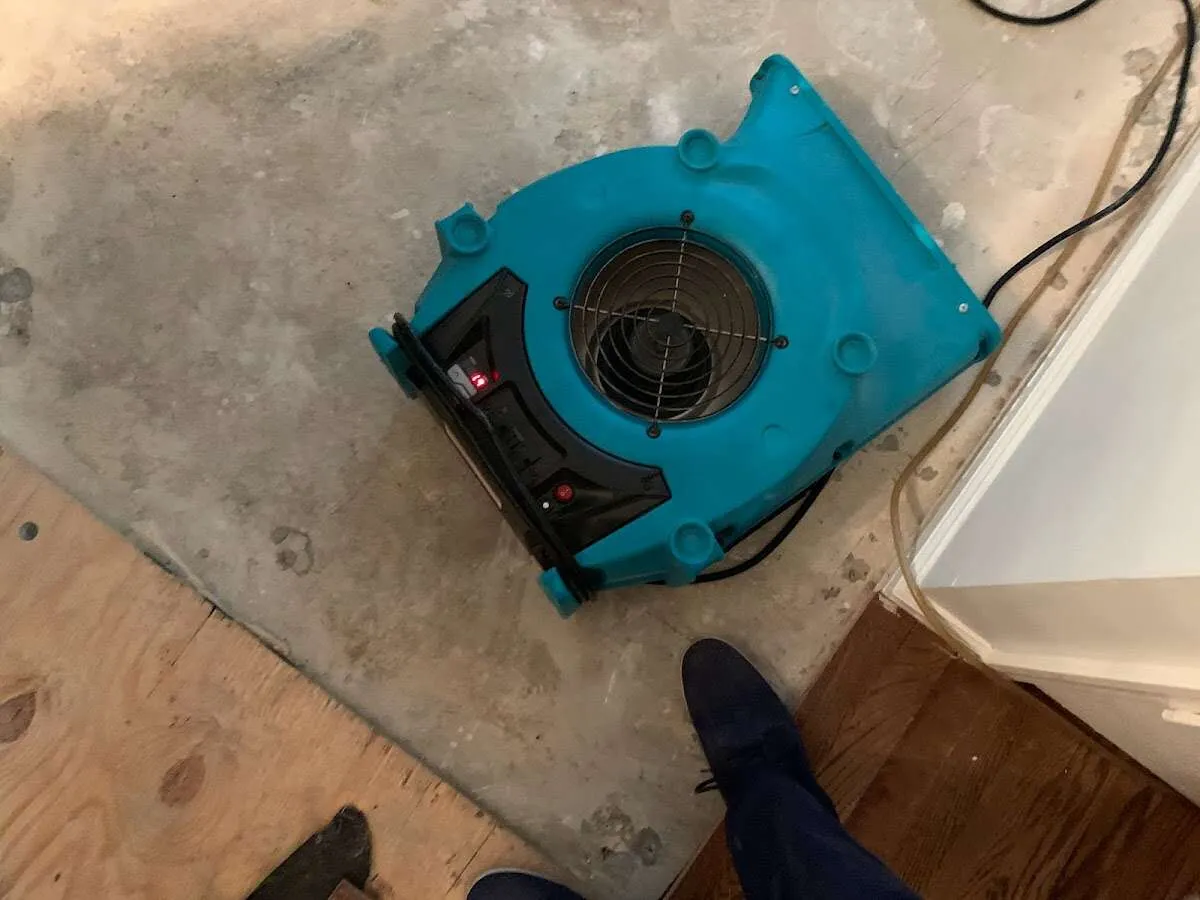 Air mover drying subfloor during Leak Detection & Repair in Wood River
